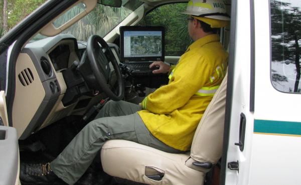 Chris Wasil, a forest area supervisor for Palm Beach County, demonstrates how satellite maps depict the location and movement of fire equipment. Chris Wasil, a forest area supervisor for Palm Beach County, demonstrates how satellite maps depict the location and movement of fire equipment.