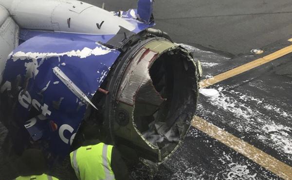 The engine on a Southwest Airlines plane is inspected as it sits on the runway at the Philadelphia International Airport after making an emergency landing there on Tuesday. The engine on a Southwest Airlines plane is inspected as it sits on the runway at the Philadelphia International Airport after making an emergency landing there on Tuesday.