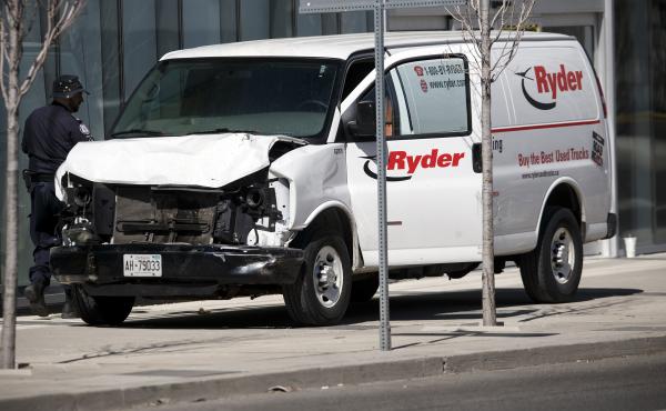 Police inspect a van suspected of being involved in a collision that killed at least 10 people and injured 15 others in Toronto on Monday. Police inspect a van suspected of being involved in a collision that killed at least 10 people and injured 15 others in Toronto on Monday.