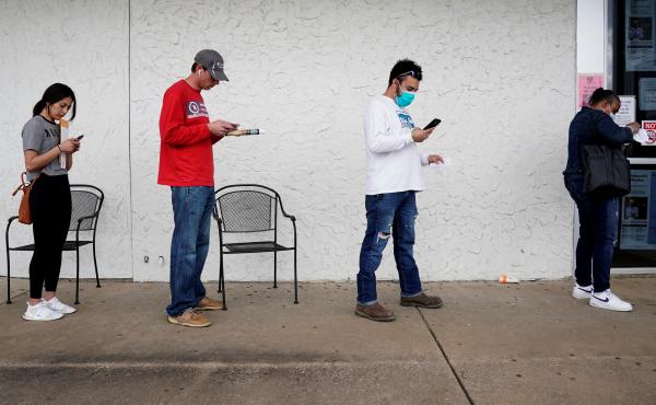 People who lost their jobs wait in line to file for unemployment benefits at an Arkansas Workforce Center in Fayetteville, Ark., on April 6. People who lost their jobs wait in line to file for unemployment benefits at an Arkansas Workforce Center in Fayetteville, Ark., on April 6.