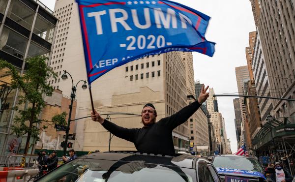 A person participates in a rally Sunday for President Trump on Fifth Avenue in New York City. Trump supporters and protesters clashed in Times Square, prompting nearly a dozen arrests. A person participates in a rally Sunday for President Trump on Fifth Avenue in New York City. Trump supporters and protesters clashed in Times Square, prompting nearly a dozen arrests.