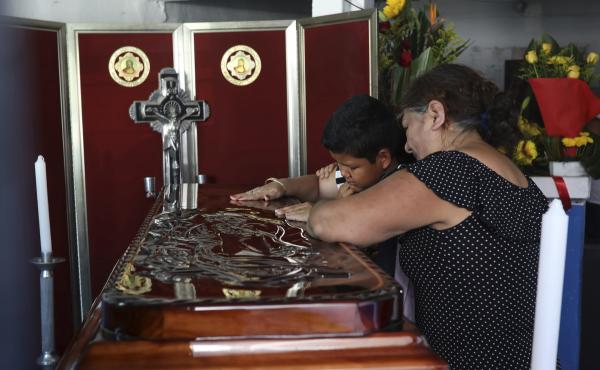 Twelve-year-old Jesús Ruiz grieves as he stands before the coffin containing the remains of his father, Mexican journalist Jorge Celestino Ruiz Vazquez, in Actopan, Veracruz, on Aug. 3. The Committee to Protect Journalists said Ruiz Vazquez was the third Twelve-year-old Jesús Ruiz grieves as he stands before the coffin containing the remains of his father, Mexican journalist Jorge Celestino Ruiz Vazquez, in Actopan, Veracruz, on Aug. 3. The Committee to Protect Journalists said Ruiz Vazquez was the third