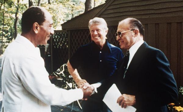 As President Jimmy Carter looks on, Egyptian President Anwar Sadat (left) shakes hands with former Israeli Prime Minister Menachem Begin at Camp David on Sept. 6, 1978. As President Jimmy Carter looks on, Egyptian President Anwar Sadat (left) shakes hands with former Israeli Prime Minister Menachem Begin at Camp David on Sept. 6, 1978.