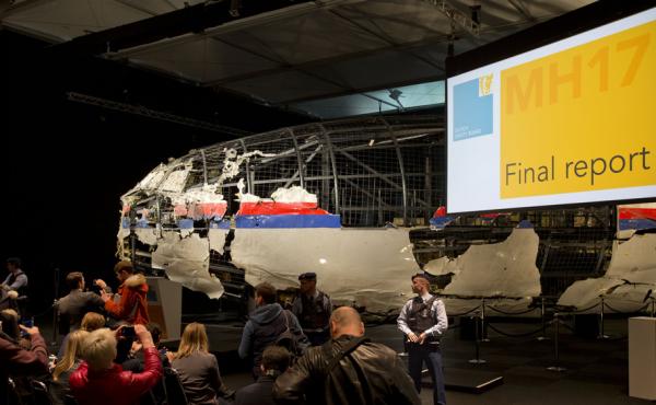Part of the reconstructed Malaysia Airlines Flight 17 plane is seen prior to the presentation of the Dutch Safety Board final report on what caused the Boeing 777 to break up high over eastern Ukraine last year. Part of the reconstructed Malaysia Airlines Flight 17 plane is seen prior to the presentation of the Dutch Safety Board final report on what caused the Boeing 777 to break up high over eastern Ukraine last year.