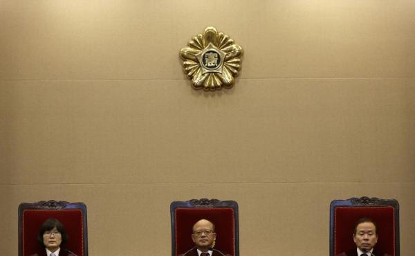 Park Han-chul (center) president of South Korea's Constitutional Court, sits with other judges prior to the ruling on the country's adultery law Thursday in Seoul. Park Han-chul (center) president of South Korea's Constitutional Court, sits with other judges prior to the ruling on the country's adultery law Thursday in Seoul.