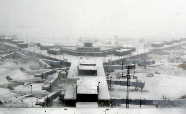 Airplanes stand in the snow at O'Hare International Airport on Sunday in Chicago. The city received 19 inches of snow from a storm that is now in the Northeast. Airplanes stand in the snow at O'Hare International Airport on Sunday in Chicago. The city received 19 inches of snow from a storm that is now in the Northeast.