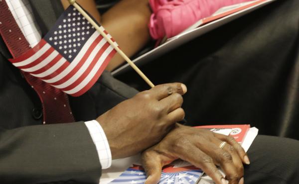 A new U.S. citizen holds an American flag during a naturalization ceremony in July. An Arizona law will require graduating high school seniors to pass the same civics test given to candidates for U.S. citizenship. A new U.S. citizen holds an American flag during a naturalization ceremony in July. An Arizona law will require graduating high school seniors to pass the same civics test given to candidates for U.S. citizenship.