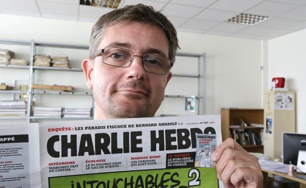 Stephane Charbonnier, the editor of Charlie Hebdo, poses with his magazine on Sept. 19, 2012. The magazine, which was attacked today, is part of a long tradition of French satire. Stephane Charbonnier, the editor of Charlie Hebdo, poses with his magazine on Sept. 19, 2012. The magazine, which was attacked today, is part of a long tradition of French satire.
