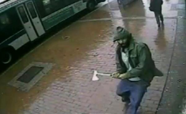 In this frame grab taken from video provided by the New York Police Department, an unidentified man approaches New York City police officers with a hatchet Thursday. The man was fatally shot by police after he wounded two officers. In this frame grab taken from video provided by the New York Police Department, an unidentified man approaches New York City police officers with a hatchet Thursday. The man was fatally shot by police after he wounded two officers.