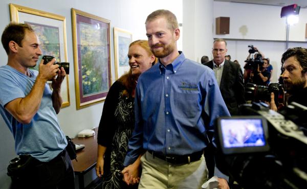 Ebola survivor Dr. Kent Brantly and his wife, Amber, leave a news conference after his release from Emory University Hospital on Aug. 21. Ebola survivor Dr. Kent Brantly and his wife, Amber, leave a news conference after his release from Emory University Hospital on Aug. 21.