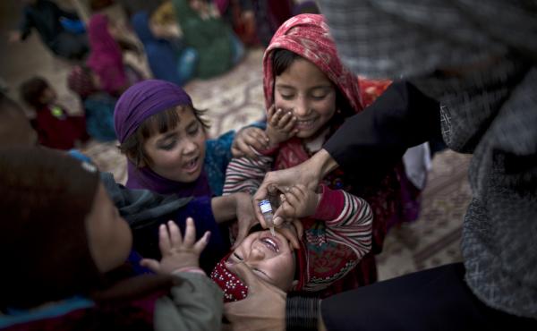 On the outskirts of Islamabad, a Pakistani health worker vaccinates an Afghan refugee against polio. On the outskirts of Islamabad, a Pakistani health worker vaccinates an Afghan refugee against polio.
