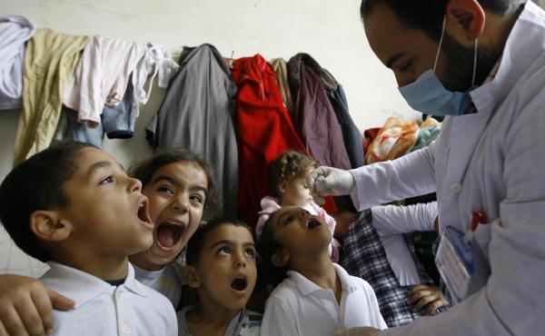 Syrian boys line up to get the polio vaccine at a refugee camp in Sidon, Lebanon, on Nov. 7. The Lebanese government plans to vaccinate all kids under age 5 for the virus, including Syrian refugees. Syrian boys line up to get the polio vaccine at a refugee camp in Sidon, Lebanon, on Nov. 7. The Lebanese government plans to vaccinate all kids under age 5 for the virus, including Syrian refugees.