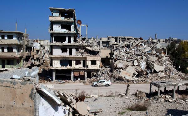 A car drives through a devastated part of the old city of Homs, Syria, on Friday. A car drives through a devastated part of the old city of Homs, Syria, on Friday.