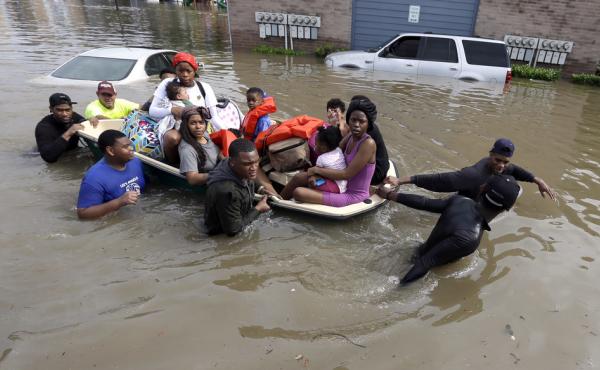 Residents evacuate their apartment complex Monday in Houston. Residents evacuate their apartment complex Monday in Houston.