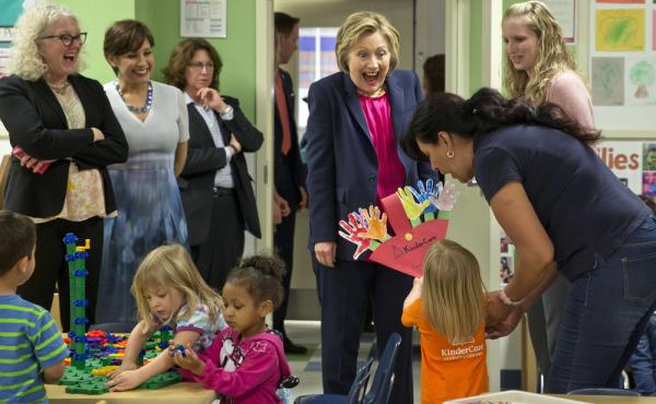 A 3-year-old presents her artwork to Hillary Clinton at Lee Highway KinderCare in Fairfax, Va. A 3-year-old presents her artwork to Hillary Clinton at Lee Highway KinderCare in Fairfax, Va.
