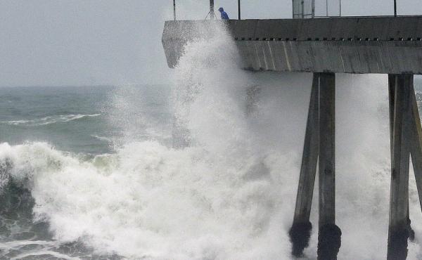 A man observes crashing waves from the Pacifica Pier in Pacifica, Calif., in January. A man observes crashing waves from the Pacifica Pier in Pacifica, Calif., in January.