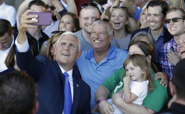 Republican vice presidential nominee Gov. Mike Pence of Indiana takes photos with supporters during a Welcome Home Rally on Saturday in Zionsville, Ind. Pence is a passionate advocate for school choice and state control over federal oversight. Republican vice presidential nominee Gov. Mike Pence of Indiana takes photos with supporters during a Welcome Home Rally on Saturday in Zionsville, Ind. Pence is a passionate advocate for school choice and state control over federal oversight.