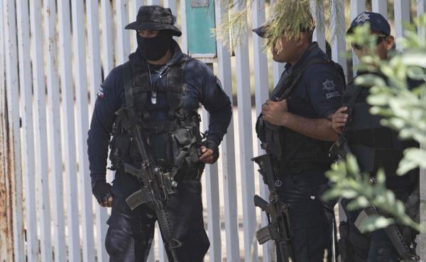 Mexican state police stand guard in May 2015 near a shootout between authorities and suspected criminals in Michoacan. Mexico's National Human Rights Commission said Thursday that 22 people were arbitrarily killed by federal police during that raid. Mexican state police stand guard in May 2015 near a shootout between authorities and suspected criminals in Michoacan. Mexico's National Human Rights Commission said Thursday that 22 people were arbitrarily killed by federal police during that raid.