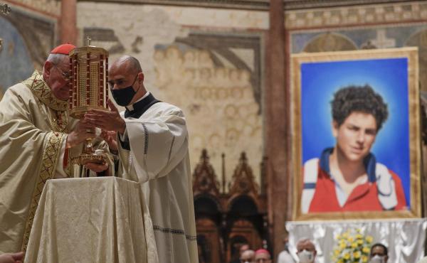 Cardinal Agostino Vallini, left, holds a relic of 15-year-old Carlo Acutis, an Italian boy who died in 2006 of leukemia, during his beatification ceremony celebrated in the St. Francis Basilica, in Assisi, Italy, on Saturday. Cardinal Agostino Vallini, left, holds a relic of 15-year-old Carlo Acutis, an Italian boy who died in 2006 of leukemia, during his beatification ceremony celebrated in the St. Francis Basilica, in Assisi, Italy, on Saturday.