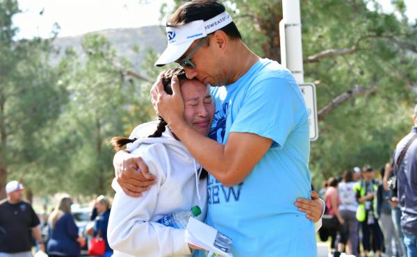 A man embraces his daughter after picking her up at Central Park in Santa Clarita, Calif., after a shooting at Saugus High School on Thursday. At least two people died in the attack, according to local law enforcement. A man embraces his daughter after picking her up at Central Park in Santa Clarita, Calif., after a shooting at Saugus High School on Thursday. At least two people died in the attack, according to local law enforcement.