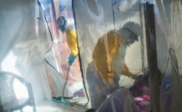 Health workers in protective suits tend to an Ebola victim kept in an isolation cube in Beni in the Democratic Republic of Congo. Health workers in protective suits tend to an Ebola victim kept in an isolation cube in Beni in the Democratic Republic of Congo.