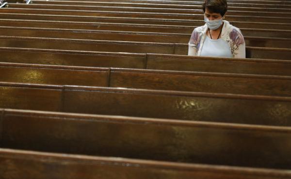 A parishioner sits after Mass last month at a Catholic church in New York City. An overwhelming majority of U.S. adults believe that houses of worship should be subject to the same restrictions on public gatherings that apply to other institutions. A parishioner sits after Mass last month at a Catholic church in New York City. An overwhelming majority of U.S. adults believe that houses of worship should be subject to the same restrictions on public gatherings that apply to other institutions.