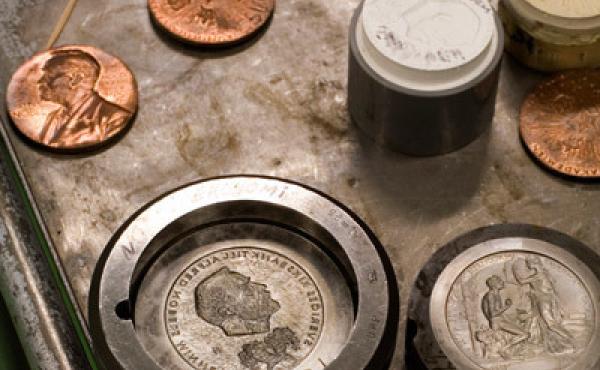 Nobel Prize gold medals during manufacture at the Swedish Mint. The front of the medal has the likeness of Alfred Nobel. Nobel Prize gold medals during manufacture at the Swedish Mint. The front of the medal has the likeness of Alfred Nobel.