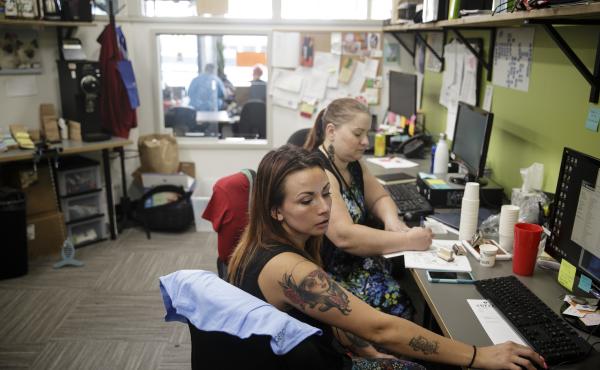 Amber Lakin (front) and colleague Julia Porras work at Central City Concern, an organization that does outreach and job training to combat homelessness and addiction in Portland, Ore. Lakin went through the welfare system and now works with Central City C Amber Lakin (front) and colleague Julia Porras work at Central City Concern, an organization that does outreach and job training to combat homelessness and addiction in Portland, Ore. Lakin went through the welfare system and now works with Central City C