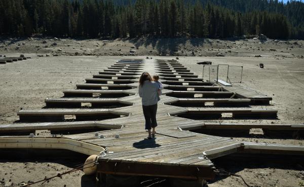 Marina owner Mitzi Richards carries her granddaughter in September as they walk on their boat dock at the dried up lake bed of Huntington Lake in California, which was at only 30 percent capacity as a severe drought continued. The state was in the grip of Marina owner Mitzi Richards carries her granddaughter in September as they walk on their boat dock at the dried up lake bed of Huntington Lake in California, which was at only 30 percent capacity as a severe drought continued. The state was in the grip of