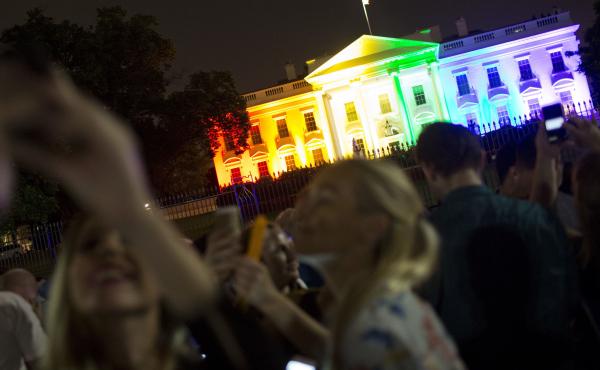 Crowds of people take photos of the White House lighted in the rainbow colors in Washington on June 26, 2015. Crowds of people take photos of the White House lighted in the rainbow colors in Washington on June 26, 2015.