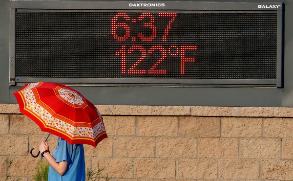 A pedestrian uses an umbrella to get some relief from the sun as they walk past a sign displaying the temperature on June 20, 2017 in Phoenix, Arizona. As 2020 comes to a close so does the hottest recorded decade. A pedestrian uses an umbrella to get some relief from the sun as they walk past a sign displaying the temperature on June 20, 2017 in Phoenix, Arizona. As 2020 comes to a close so does the hottest recorded decade.