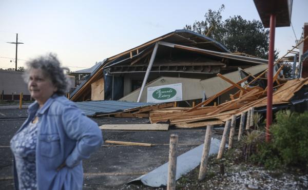 A woman stands in front of a destroyed restaurant after Hurricane Zeta on Oct. 29, 2020, in Chalmette, La. In a postseason analysis, NOAA upgraded Zeta's windspeeds, saying it was a "major" Category 3 storm when it hit. A woman stands in front of a destroyed restaurant after Hurricane Zeta on Oct. 29, 2020, in Chalmette, La. In a postseason analysis, NOAA upgraded Zeta's windspeeds, saying it was a "major" Category 3 storm when it hit.