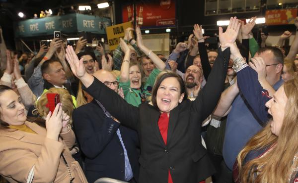 Sinn Fein leader Mary Lou McDonald (dressed in red and black) celebrates with party supporters Sunday after receiving poll results in Dublin. Sinn Fein leader Mary Lou McDonald (dressed in red and black) celebrates with party supporters Sunday after receiving poll results in Dublin.