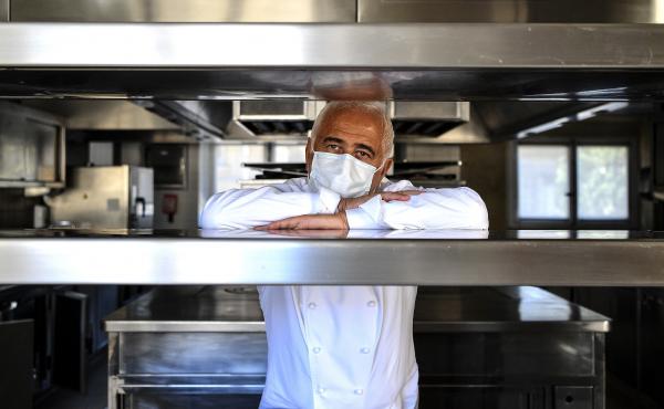 French chef Guy Savoy poses with a face mask in the kitchen of one of his restaurants, in the Monnaie de Paris building, on Tuesday. French chef Guy Savoy poses with a face mask in the kitchen of one of his restaurants, in the Monnaie de Paris building, on Tuesday.