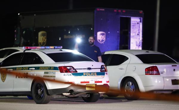 An FBI official at the scene of a shooting, Thursday in Miramar, Fla. Four people, including a UPS driver, were killed in the shootout between the armed robbers and police authorities. An FBI official at the scene of a shooting, Thursday in Miramar, Fla. Four people, including a UPS driver, were killed in the shootout between the armed robbers and police authorities.
