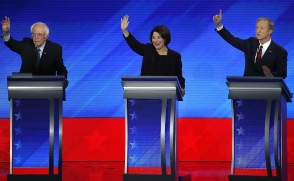 Democratic presidential candidates, Sen. Bernie Sanders (left), Sen. Amy Klobuchar and businessman Tom Steyer raise their hands during a Democratic presidential primary debate on Friday at Saint Anselm College in Manchester, N.H. Democratic presidential candidates, Sen. Bernie Sanders (left), Sen. Amy Klobuchar and businessman Tom Steyer raise their hands during a Democratic presidential primary debate on Friday at Saint Anselm College in Manchester, N.H.