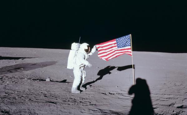From NASA: Apollo 12 commander Charles "Pete" Conrad unfurls the United States flag on the lunar surface during the first extravehicular activity on Nov. 19, 1969. From NASA: Apollo 12 commander Charles "Pete" Conrad unfurls the United States flag on the lunar surface during the first extravehicular activity on Nov. 19, 1969.