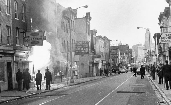 Fire shoots out from a Baltimore store on Gay Street as looting erupted in a five-block business section in Baltimore on April 6, 1968. Police sealed off the area. Fire shoots out from a Baltimore store on Gay Street as looting erupted in a five-block business section in Baltimore on April 6, 1968. Police sealed off the area.