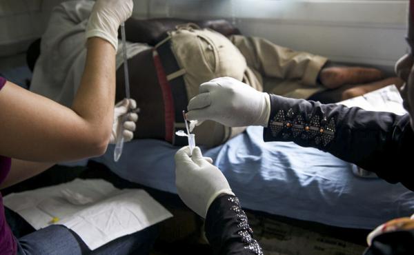 Fred Muzaya, a 26-year-old Ugandan who has AIDS, prepares for a spinal tap to relieve the pressure in his skull, brought on by the fungal disease cryptococcal meningitis. Fred Muzaya, a 26-year-old Ugandan who has AIDS, prepares for a spinal tap to relieve the pressure in his skull, brought on by the fungal disease cryptococcal meningitis.