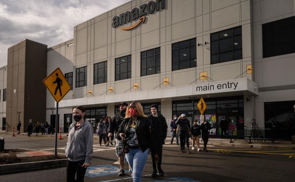 Workers walk to cast their votes over whether or not to unionize, at an Amazon warehouse on Staten Island on March 25, 2022. Another Amazon warehouse across the street began voting on a union on Monday. Workers walk to cast their votes over whether or not to unionize, at an Amazon warehouse on Staten Island on March 25, 2022. Another Amazon warehouse across the street began voting on a union on Monday.