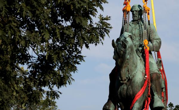 Workers remove a statue of Confederate Gen. Robert E. Lee from Market Street Park in Charlottesville, Va., in July. Initial plans to remove the statue four years ago sparked the infamous "Unite the Right" rally at which 32-year-old Heather Heyer was kille Workers remove a statue of Confederate Gen. Robert E. Lee from Market Street Park in Charlottesville, Va., in July. Initial plans to remove the statue four years ago sparked the infamous "Unite the Right" rally at which 32-year-old Heather Heyer was kille