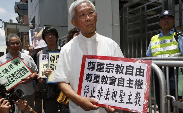 Hong Kong's outspoken cardinal Joseph Zen, center, and other religious protesters hold placards with "Respects religious freedom" written on them during a demonstration outside the China Liaison Office in Hong Kong, Wednesday, July 11, 2012. Hong Kong's outspoken cardinal Joseph Zen, center, and other religious protesters hold placards with "Respects religious freedom" written on them during a demonstration outside the China Liaison Office in Hong Kong, Wednesday, July 11, 2012.