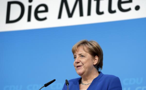 German Chancellor Angela Merkel, who is also chairwoman of the German Christian Democratic Union, announces a new deal with Horst Seehofer, the interior minister and chairman of Bavaria's Christian Social Union, in Berlin on Monday. German Chancellor Angela Merkel, who is also chairwoman of the German Christian Democratic Union, announces a new deal with Horst Seehofer, the interior minister and chairman of Bavaria's Christian Social Union, in Berlin on Monday.