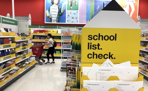 A shopper walks past shelves of school supplies at a Target store in San Rafael, Calif. Preparing for both in-person and virtual learning has families budgeting for new school supplies and bigger purchases. A shopper walks past shelves of school supplies at a Target store in San Rafael, Calif. Preparing for both in-person and virtual learning has families budgeting for new school supplies and bigger purchases.