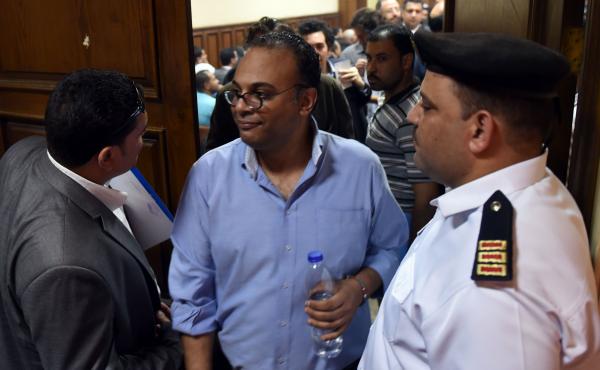 Egyptian human rights activist Hossam Bahgat (center) leaves a Cairo courtroom on Wednesday after a hearing in which the state requested a travel ban and freeze of his assests. The government has taken action against a number of groups and activists in wh Egyptian human rights activist Hossam Bahgat (center) leaves a Cairo courtroom on Wednesday after a hearing in which the state requested a travel ban and freeze of his assests. The government has taken action against a number of groups and activists in wh