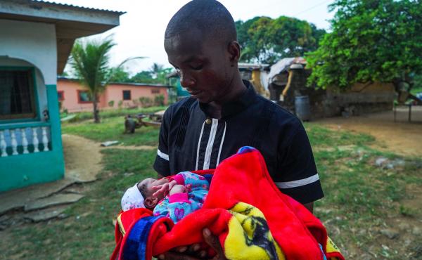 James Harris holds his newborn son, Jeremiah Solomon Karwah. James Harris holds his newborn son, Jeremiah Solomon Karwah.