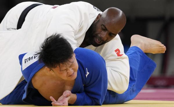 Riner (top) and Japan's Hisayoshi Harasawa compete Friday during the men's over 100-kilogram bronze medal judo match. Riner (top) and Japan's Hisayoshi Harasawa compete Friday during the men's over 100-kilogram bronze medal judo match.