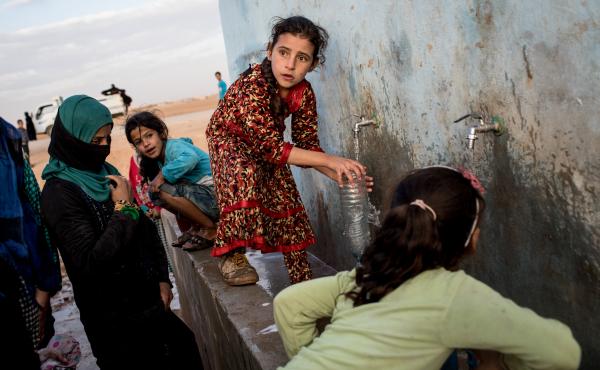 Access to water is increasingly entangled with conflict situations. (Above) A young girl fills a bottle at a pump station at a camp for internally displaced people in Ain Issa, Syria. Access to water is increasingly entangled with conflict situations. (Above) A young girl fills a bottle at a pump station at a camp for internally displaced people in Ain Issa, Syria.
