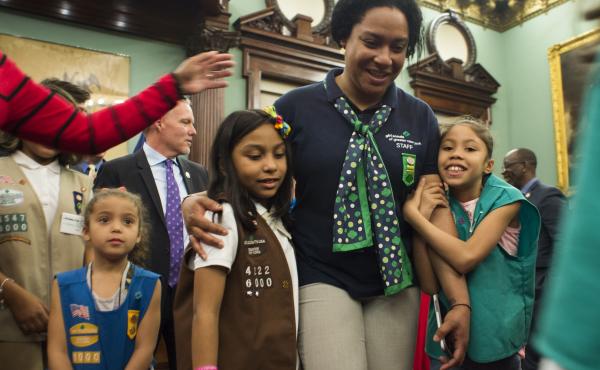 Members of Girl Scout Troop 6000 troop and leader Giselle Burgess hug after being honored as the first troop exclusively for homeless girls, at a ceremony at New York City Hall on April 25. Members of Girl Scout Troop 6000 troop and leader Giselle Burgess hug after being honored as the first troop exclusively for homeless girls, at a ceremony at New York City Hall on April 25.