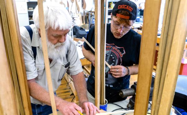 Paul Williams (left) helps Scott Beatty build his 'backpack' guitar. It has a smaller body, meant to easily fit in a pack. Beatty is in the Culture of Recovery program which teaches instrument making to people recovering from addiction. Paul Williams (left) helps Scott Beatty build his 'backpack' guitar. It has a smaller body, meant to easily fit in a pack. Beatty is in the Culture of Recovery program which teaches instrument making to people recovering from addiction.